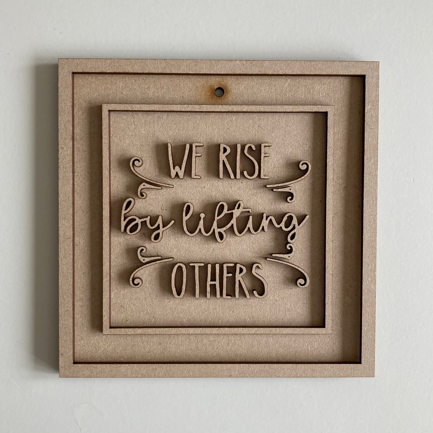 15cm We Rise By Lifting Others Sign